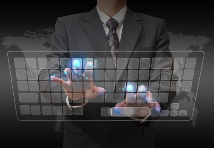 Businessman standing and working wth touch screen